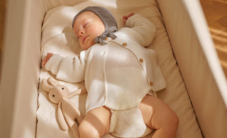 Why do babies sleep with their arms up?